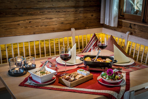 Detailbild eines gedeckten Tisch mit Schweinsbraten im Luxuschalet Bayern